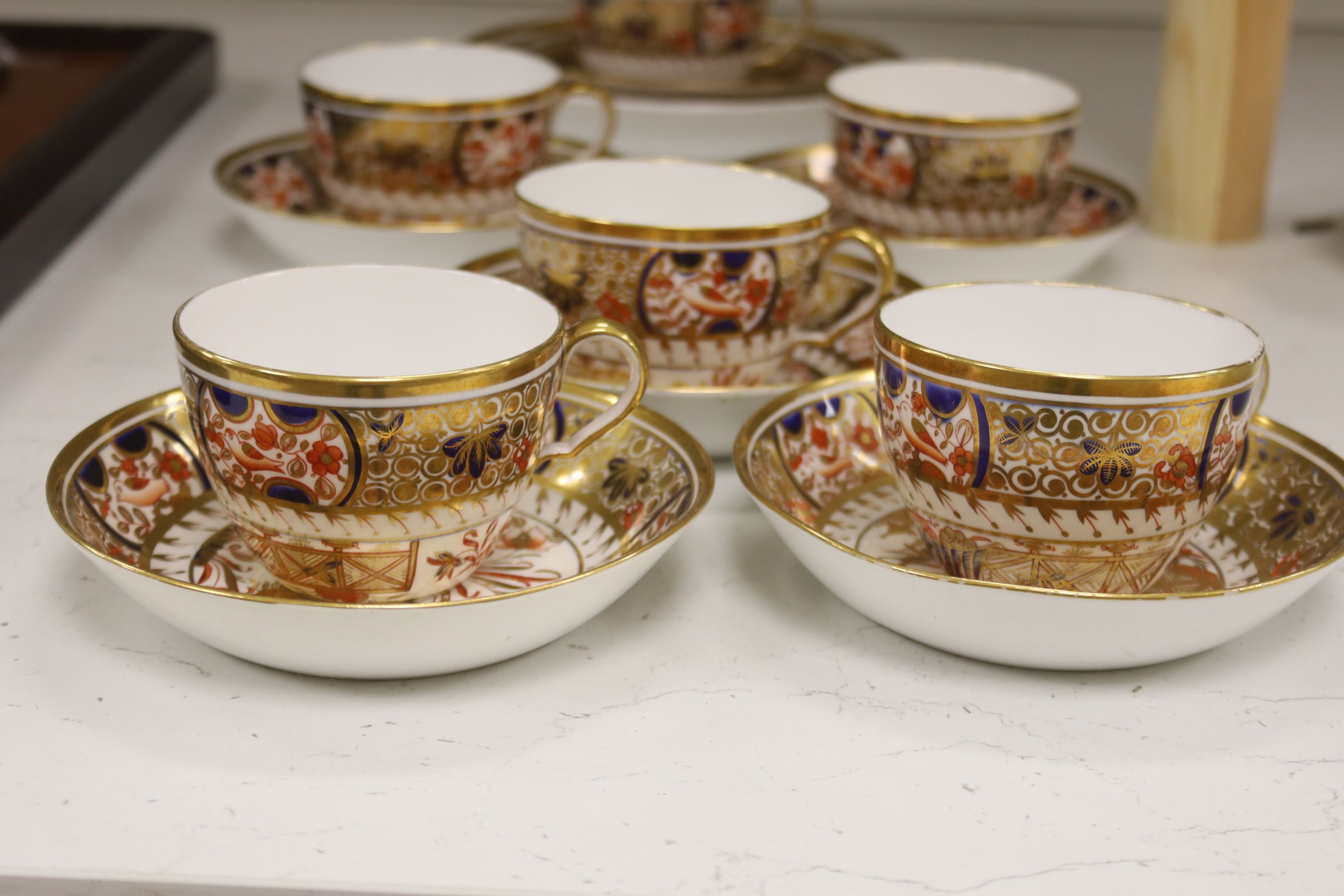 A set of six Spode teacups and saucers and a saucer dish painted with Imari pattern, amrked SPODE 1495